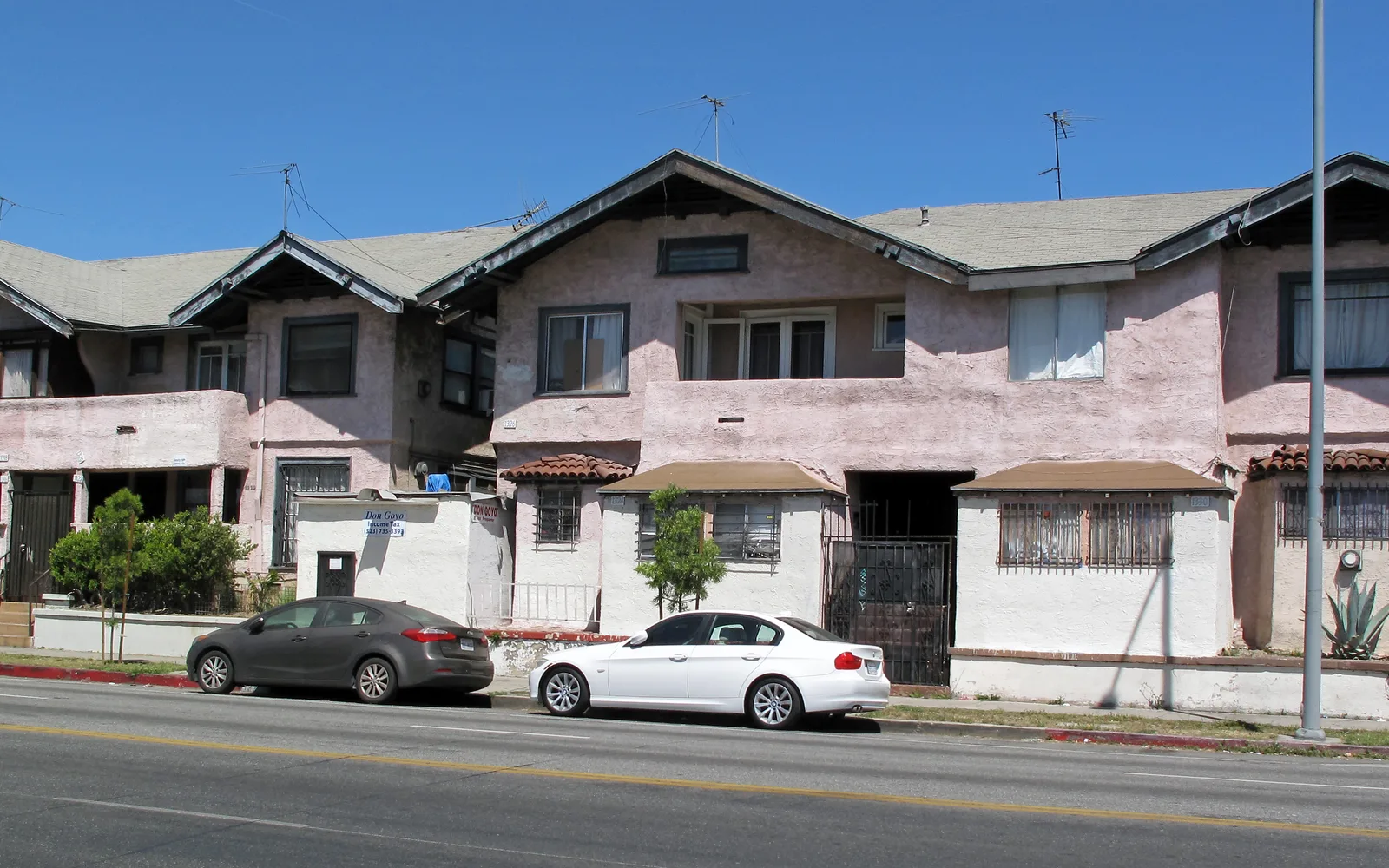 A distinctive residential building in Harvard Heights on South Western Avenue in Los Angeles, surrounded by commercial properties